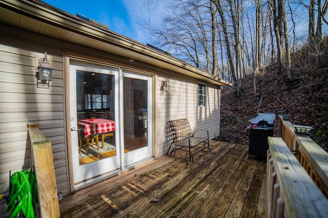 wooden terrace featuring area for grilling