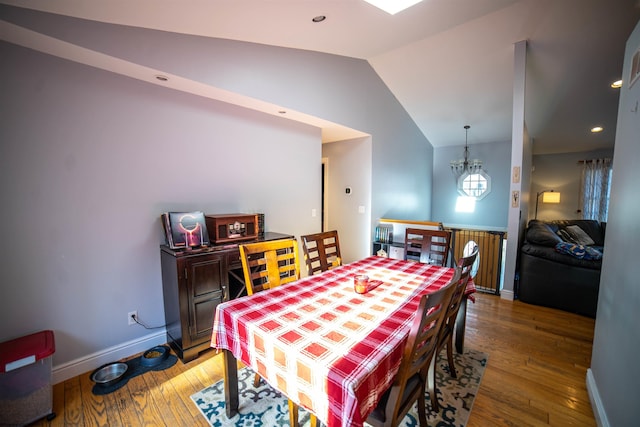 dining space with recessed lighting, baseboards, hardwood / wood-style flooring, and vaulted ceiling