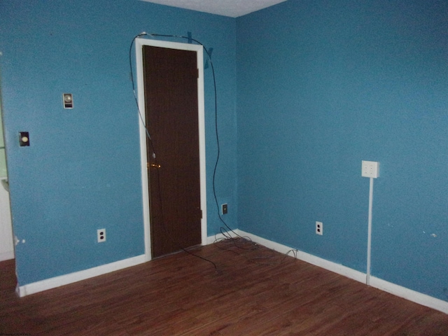 spare room featuring dark wood-type flooring