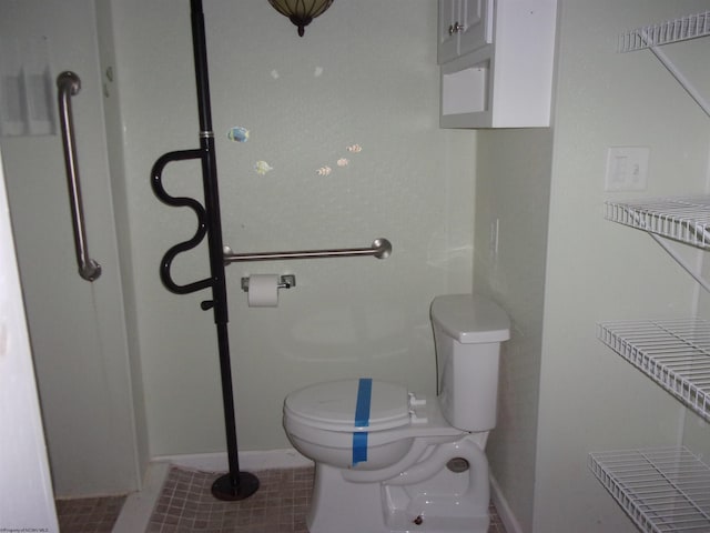 bathroom featuring tile patterned flooring and toilet