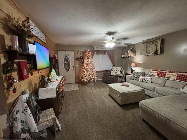 carpeted living room featuring ceiling fan and a textured ceiling