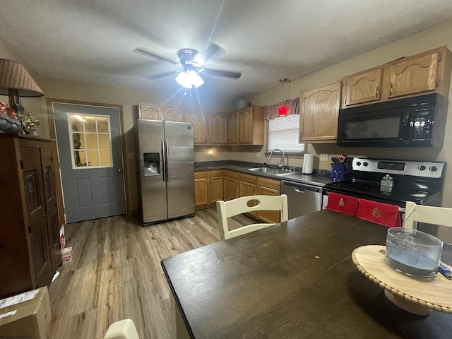 kitchen with sink, light hardwood / wood-style flooring, ceiling fan, a textured ceiling, and stainless steel appliances