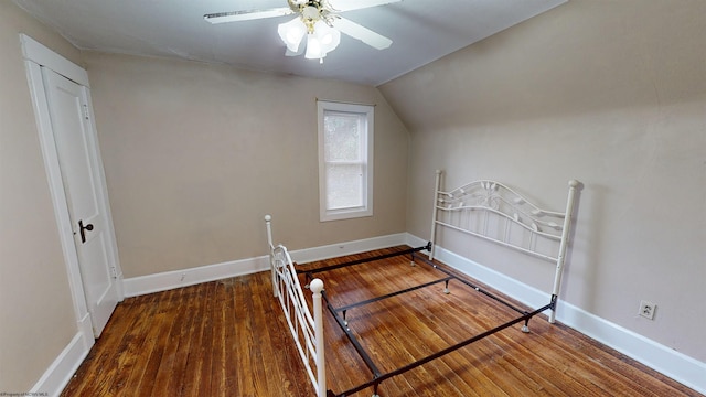 unfurnished bedroom featuring ceiling fan, lofted ceiling, and hardwood / wood-style flooring