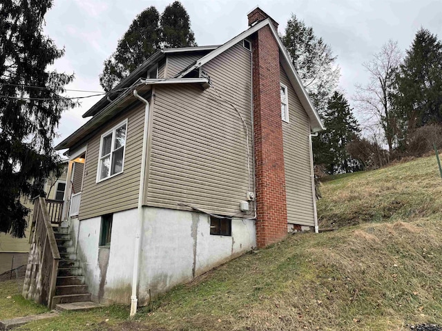 view of side of property with a lawn