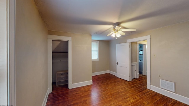 unfurnished bedroom with dark hardwood / wood-style flooring and ceiling fan