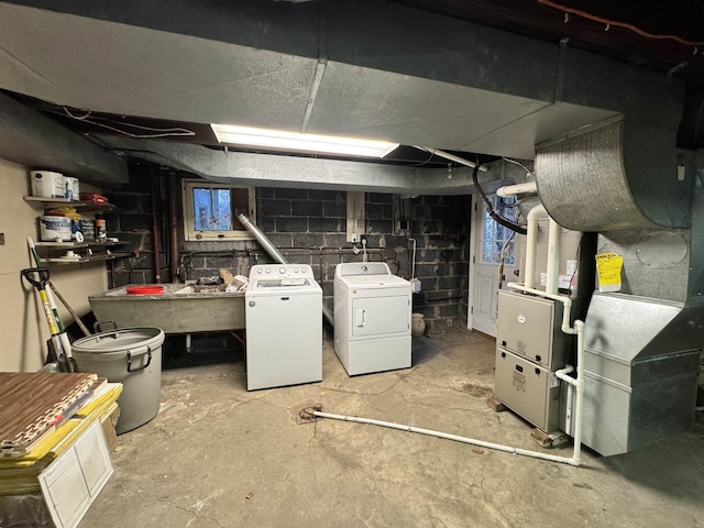 basement with separate washer and dryer and sink