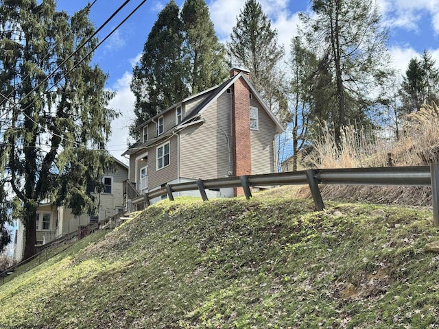 view of home's exterior with fence and a chimney