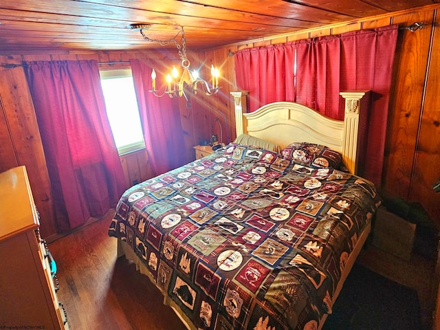 bedroom featuring wood ceiling, wood walls, an inviting chandelier, and wood finished floors