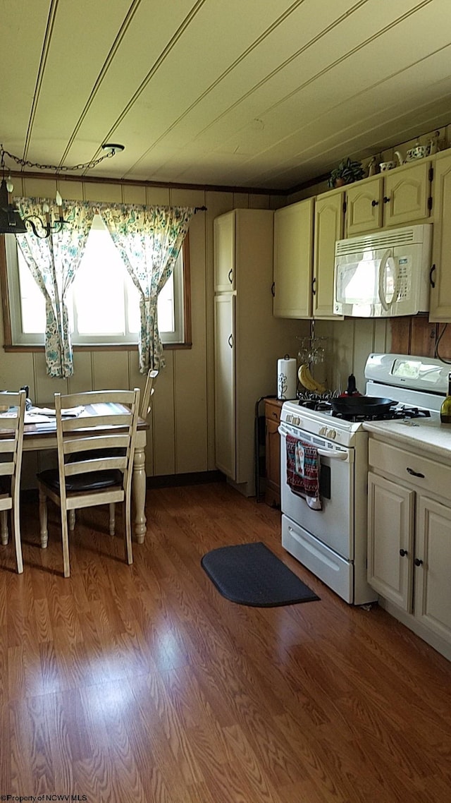 kitchen with hardwood / wood-style flooring and white appliances