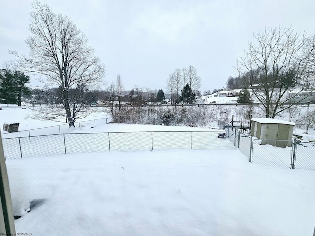 yard layered in snow featuring a fenced backyard