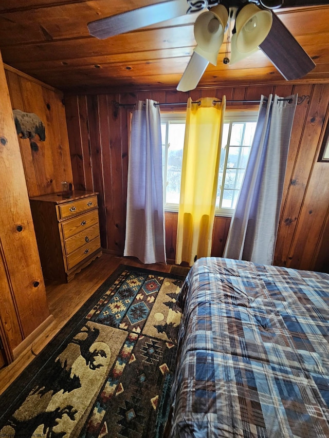 bedroom featuring wood ceiling, wooden walls, and wood finished floors