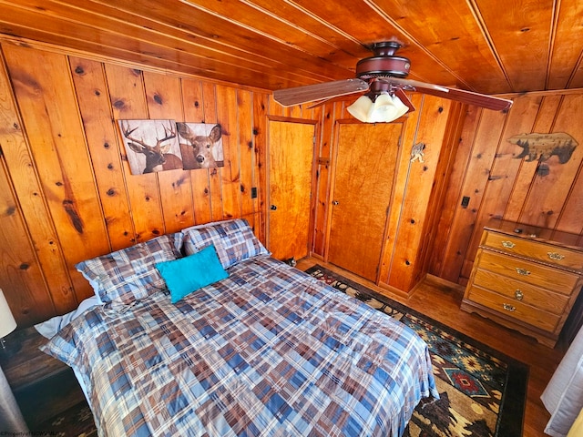 unfurnished bedroom with wood ceiling and wood walls