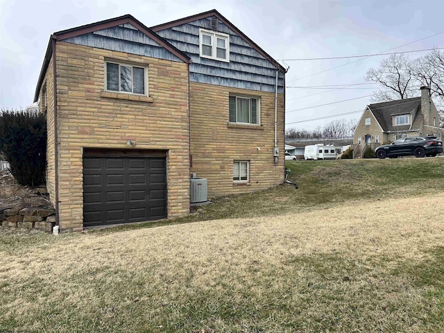 view of property exterior with a lawn, an attached garage, cooling unit, stone siding, and driveway