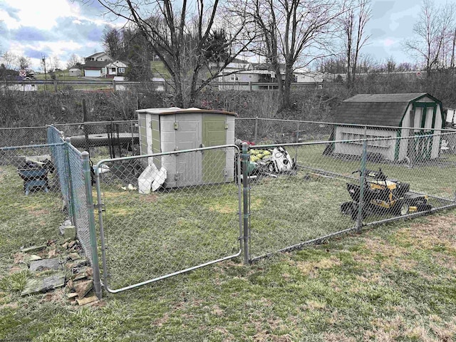 view of yard with a fenced backyard, a storage unit, and an outdoor structure