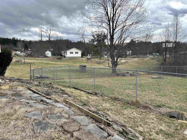 view of yard with a rural view and fence