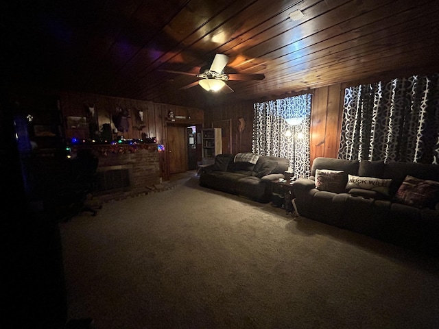 home theater with carpet flooring, wood walls, ceiling fan, and wood ceiling