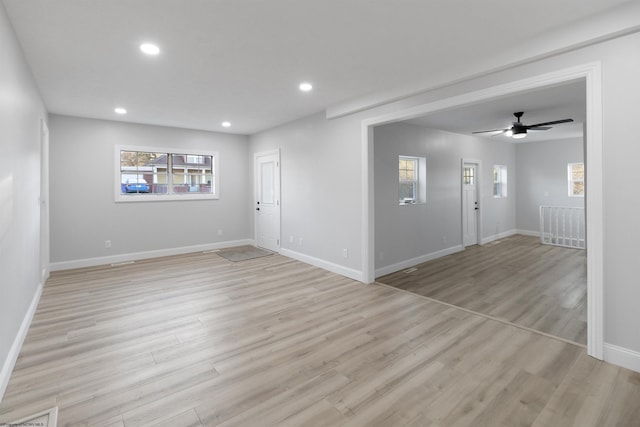 unfurnished room with ceiling fan and light wood-type flooring