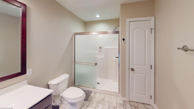 bathroom featuring toilet, vanity, wood-type flooring, and walk in shower