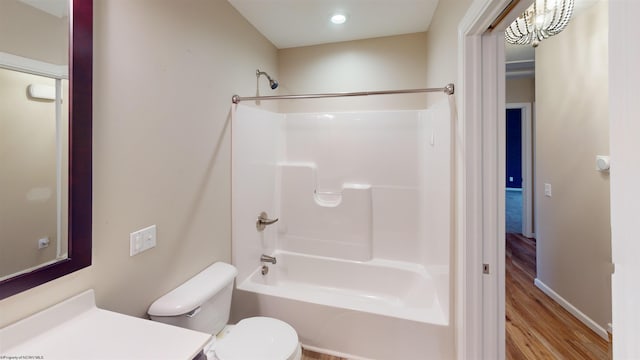 full bathroom featuring toilet, vanity, tub / shower combination, and hardwood / wood-style flooring