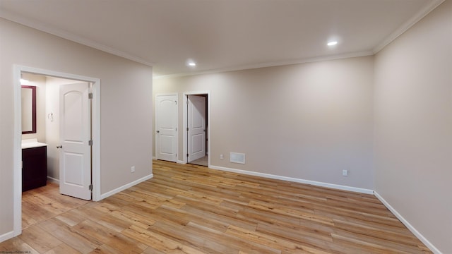 unfurnished bedroom with ensuite bathroom, light hardwood / wood-style floors, and crown molding