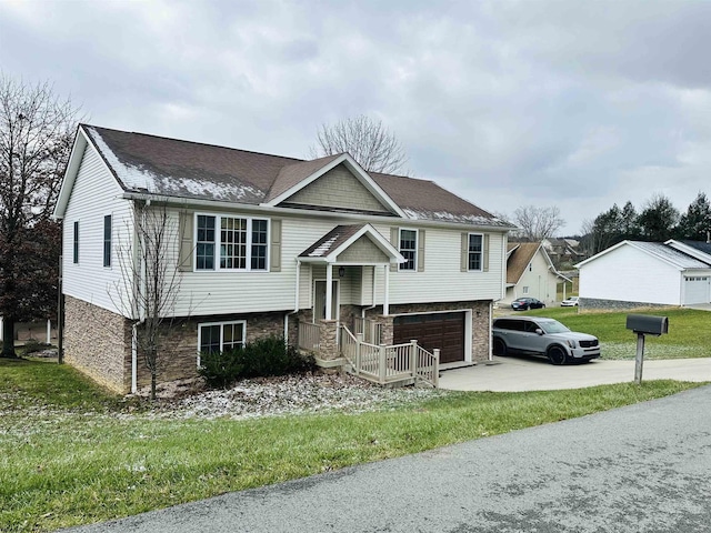 raised ranch featuring a front yard and a garage