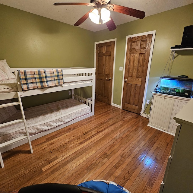 unfurnished bedroom with ceiling fan, light hardwood / wood-style flooring, and a textured ceiling