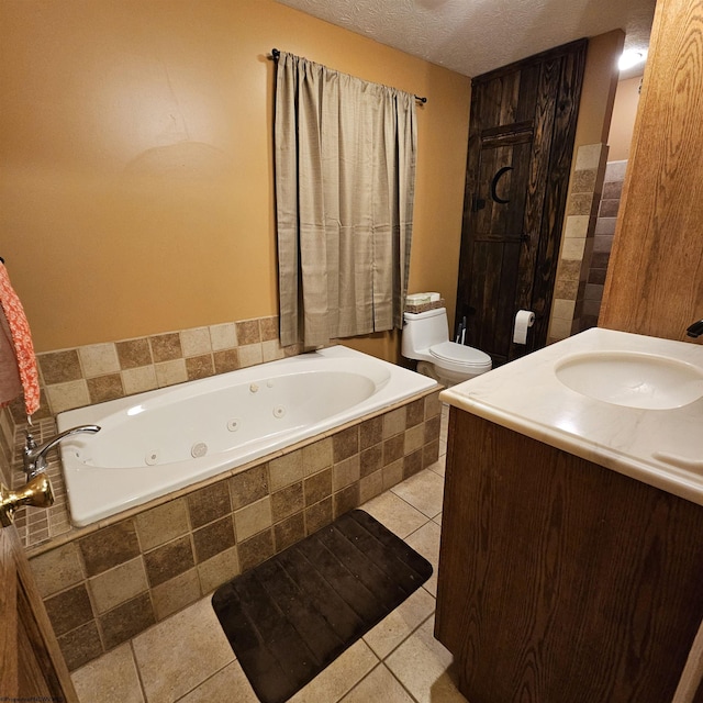 bathroom featuring tile patterned flooring, tiled tub, a textured ceiling, toilet, and vanity