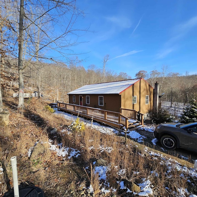 view of snow covered exterior with a deck