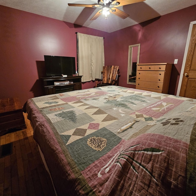 bedroom with hardwood / wood-style flooring and ceiling fan