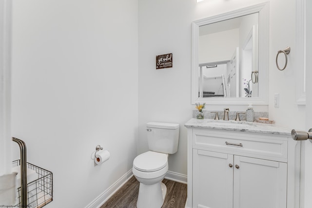 bathroom with vanity, toilet, and wood-type flooring