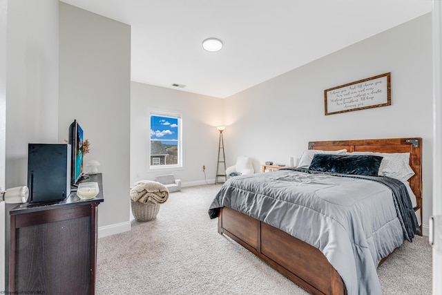 bedroom featuring light colored carpet