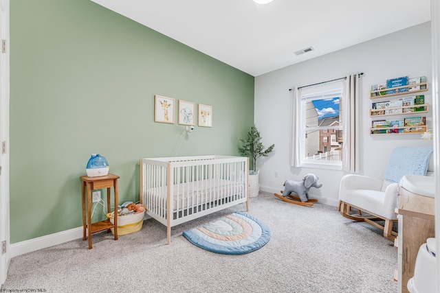 bedroom with carpet floors and a nursery area