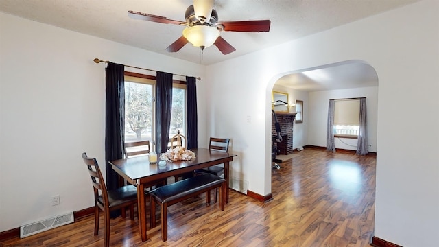 dining room featuring ceiling fan and dark wood-type flooring