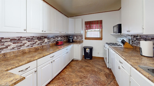 kitchen with white cabinets, white stove, and tasteful backsplash