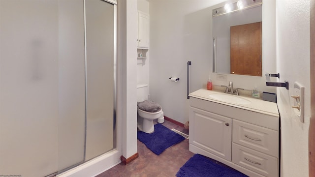 bathroom with vanity, toilet, and a shower with shower door