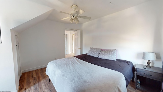 bedroom with hardwood / wood-style floors, vaulted ceiling, and ceiling fan