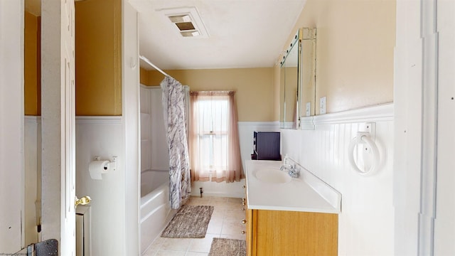 bathroom featuring tile patterned flooring, vanity, and shower / tub combo with curtain