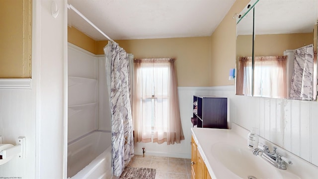 bathroom featuring vanity, a healthy amount of sunlight, and shower / bath combo