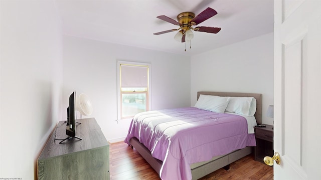 bedroom with ceiling fan and wood-type flooring