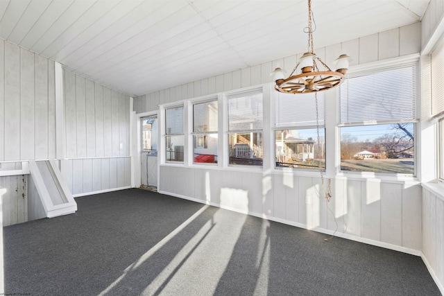 unfurnished sunroom featuring an inviting chandelier