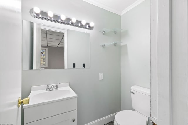 bathroom featuring vanity, toilet, and ornamental molding