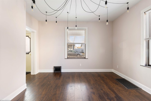 empty room featuring dark hardwood / wood-style flooring