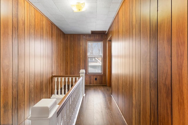 hall featuring wooden walls and dark hardwood / wood-style flooring