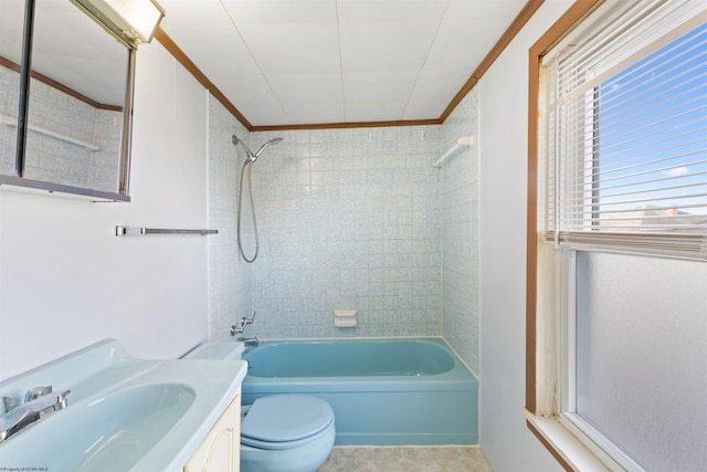 full bathroom with vanity, tiled shower / bath combo, toilet, and crown molding