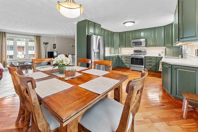 dining space featuring sink and light hardwood / wood-style floors