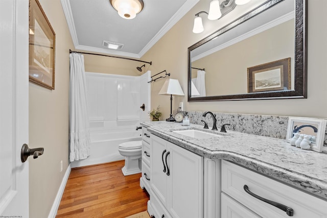 full bathroom with shower / tub combo, ornamental molding, vanity, hardwood / wood-style flooring, and toilet