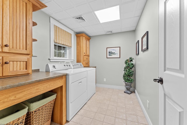 laundry area featuring cabinets and washing machine and clothes dryer