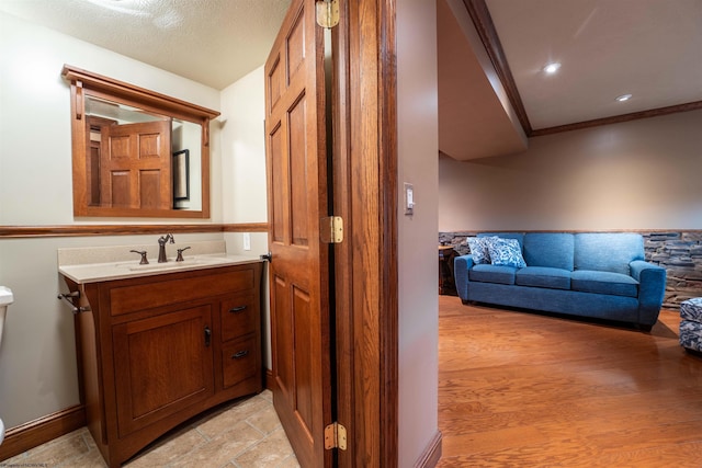 bathroom featuring crown molding, vanity, and toilet