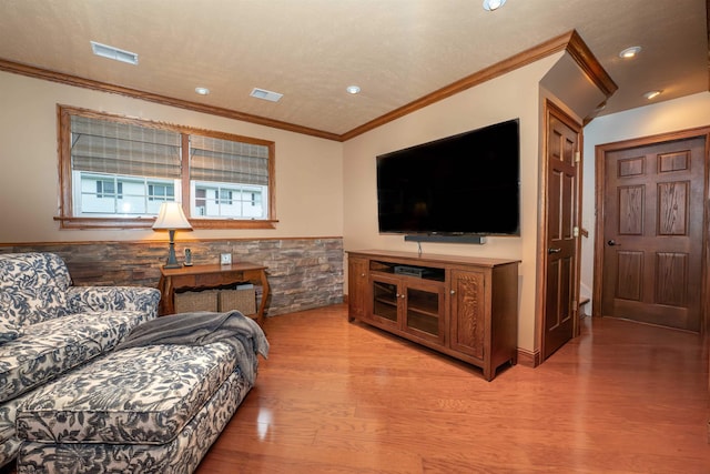 living room featuring light wood-type flooring and ornamental molding