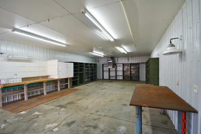 misc room with a workshop area and concrete floors